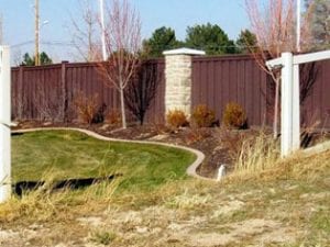 A Trex Fence in the background is still standing while a PVC vinyl fence in front has been blown out by a microburst storm.