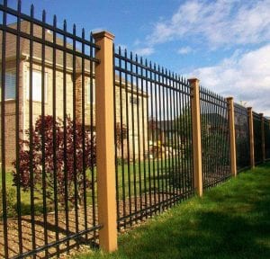 Trex fencing posts in saddles with ornamental iron fence panels