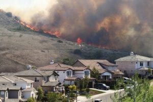 Wildfire spreading towards neighborhood homes