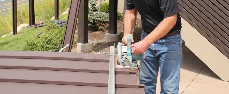 Cutting pickets with a jig to create a sloping Trex Horizons fence