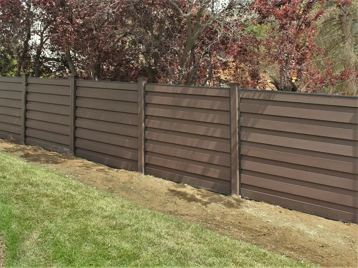 A sloped Trex horizontal fence on a hill