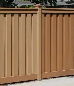 A picture of a Trex fence in Saddle color that has been partially repainted.