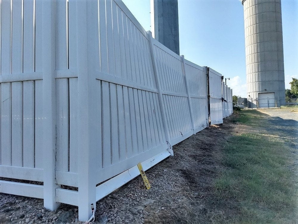 An 8 foot tall PVC vinyl fence damaged by winds