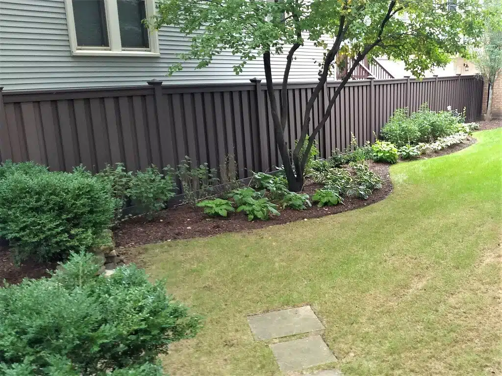 A landscaped backyard with Trex Fencing Woodland Brown 6' tall privacy fencing