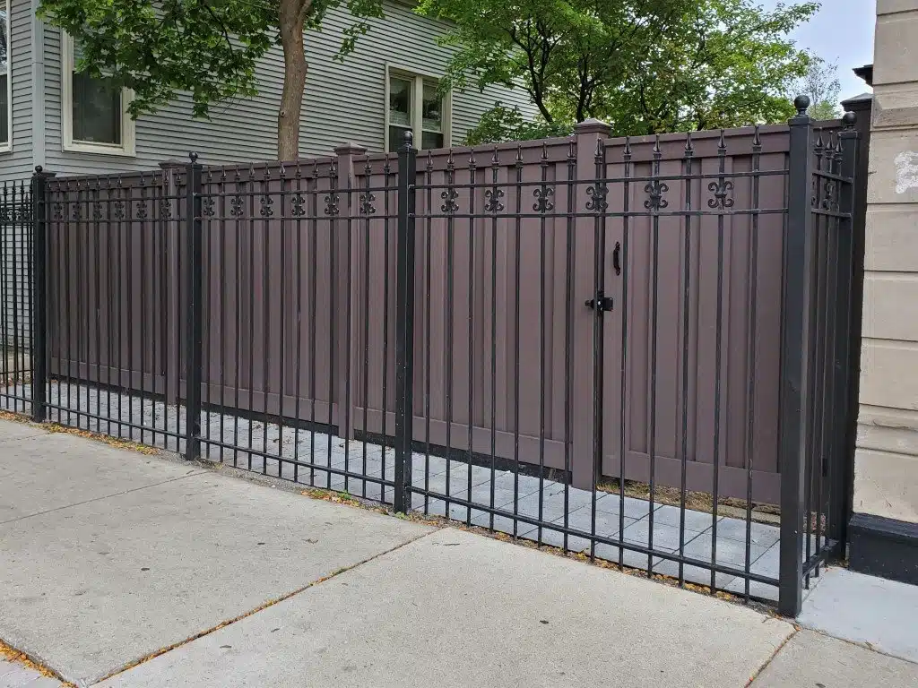 A Trex privacy fence behind an ornamental metal fence
