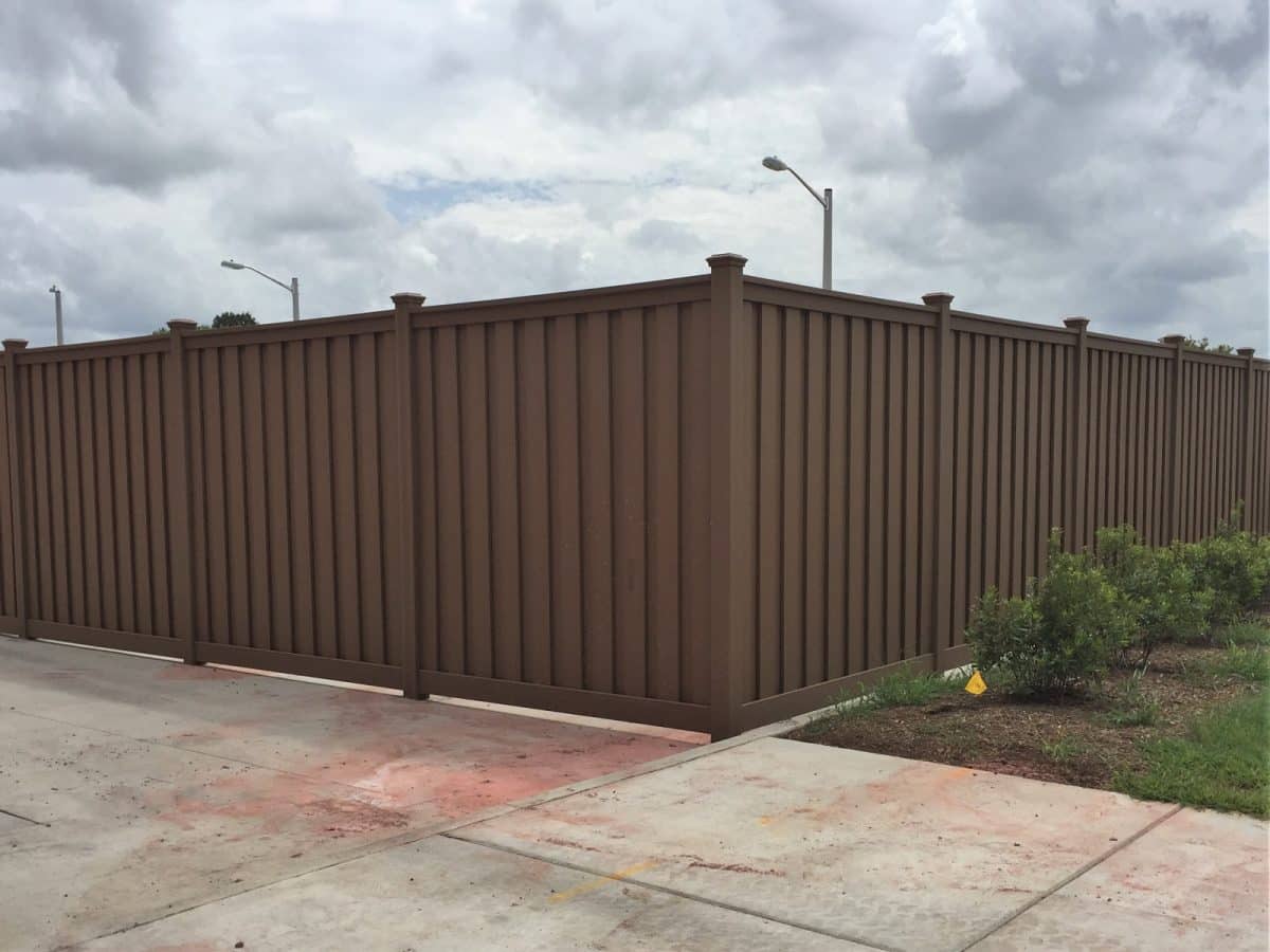 A Trex Fence next to a large concrete pad.