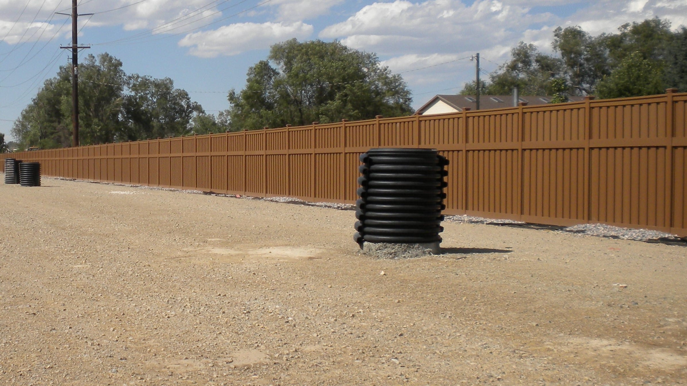 A long perimeter of Trex fencing installed for a government fencing project